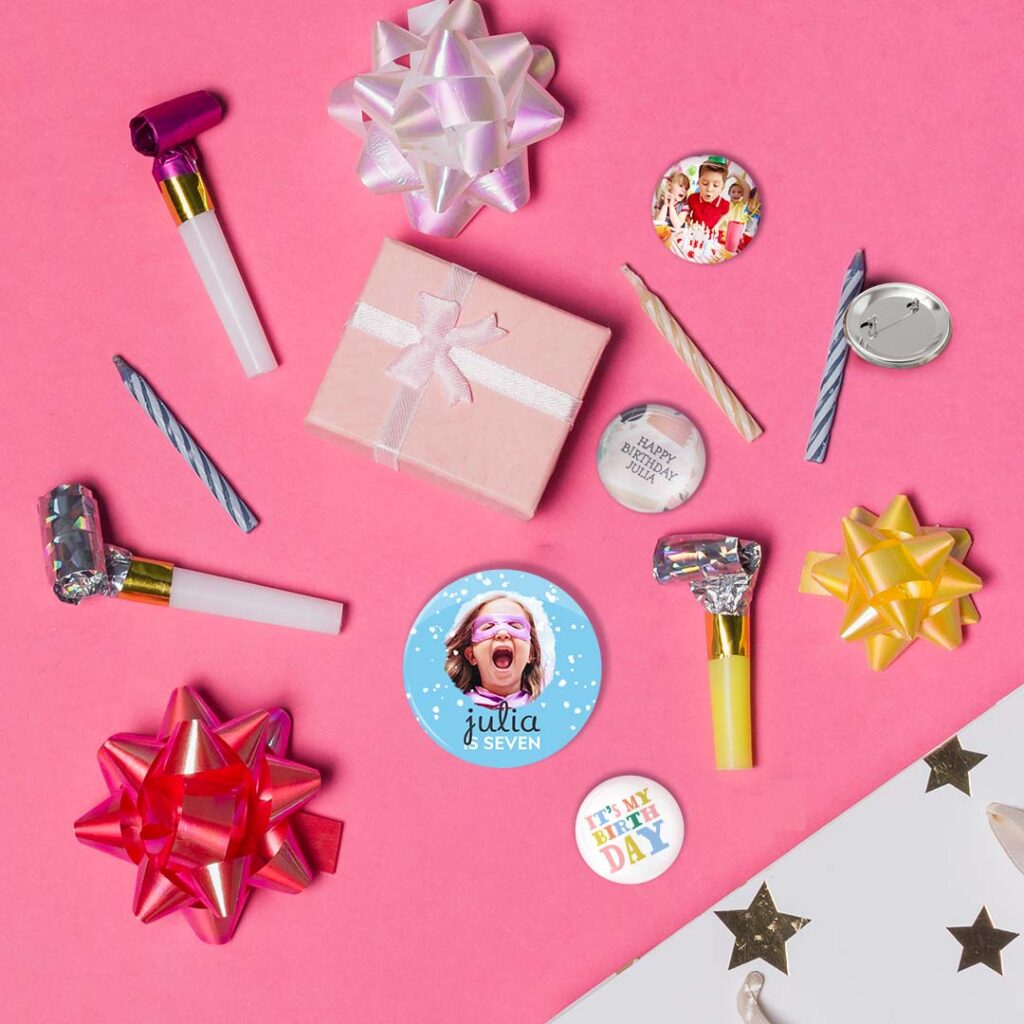 Selection of personalised birthday pin badges on a pink background
