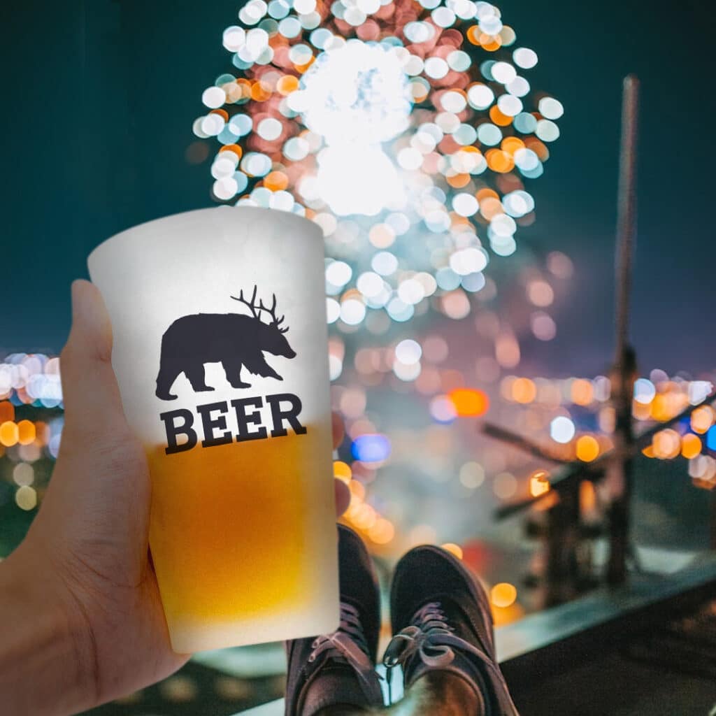frosted pint glass with fireworks in the background