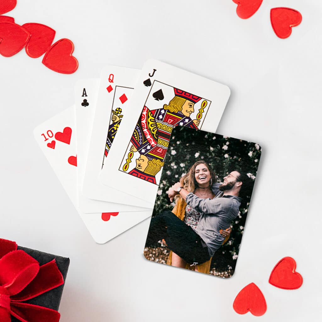 Playing cards with heart shaped decor on a table